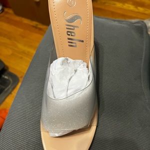 Brand new in a sealed bag, open toe strapless, high heel shoe